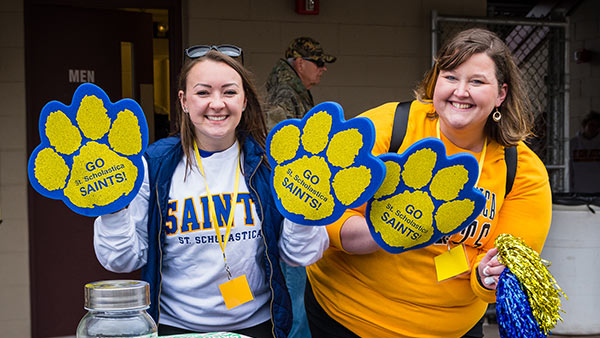 Two students showing their Saints pride during homecoming.