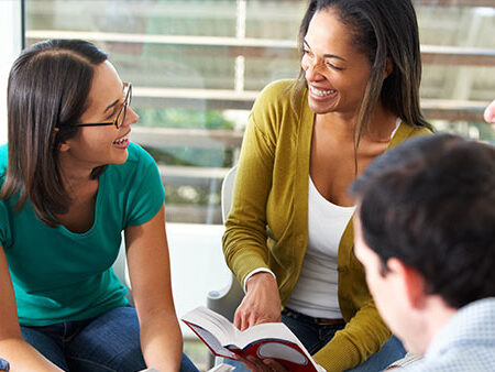 Photo of a group of people discussing a book