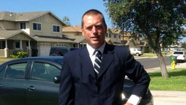 Veteran Jason Chapman standing in a residential neighborhood.