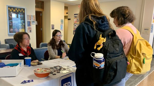 Students stand at a JED Campus table.