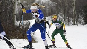 Kelsey Dickinson participating in a ski race.