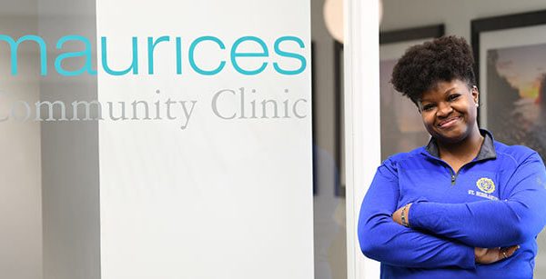 Latrice standing in front of the maurices Community Clinic