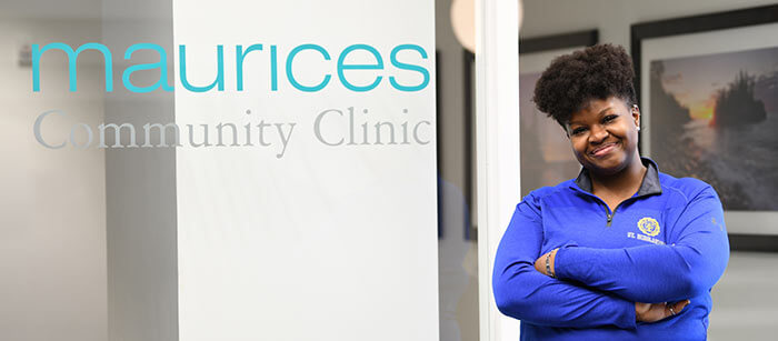 Latrice standing in front of the maurices Community Clinic