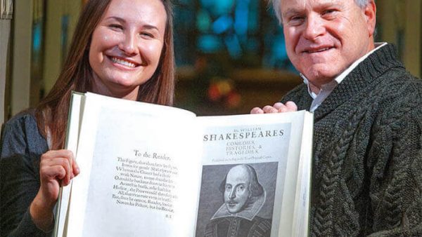 Maddie Swenson and Tom Zelman, Ph.D., holding a collection of Shakespeare