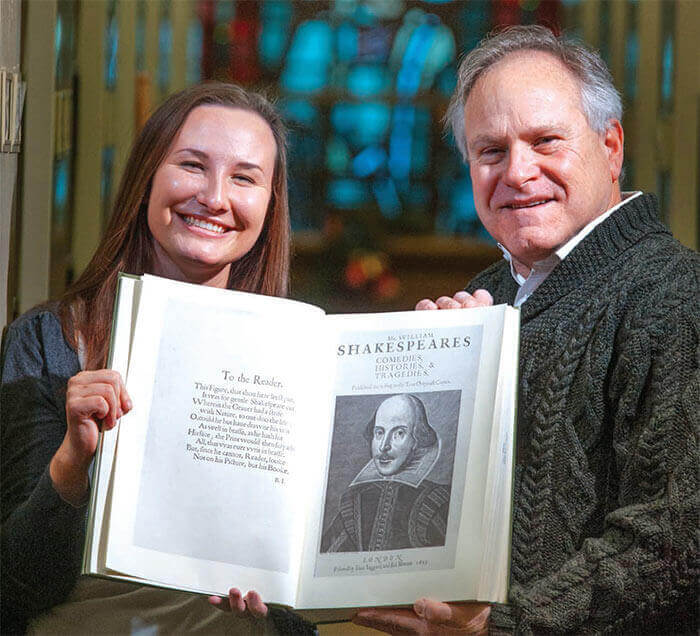 Maddie Swenson and Tom Zelman, Ph.D., holding a collection of Shakespeare