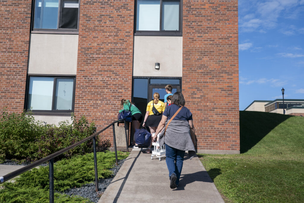 Families moving items into Somers Hall.