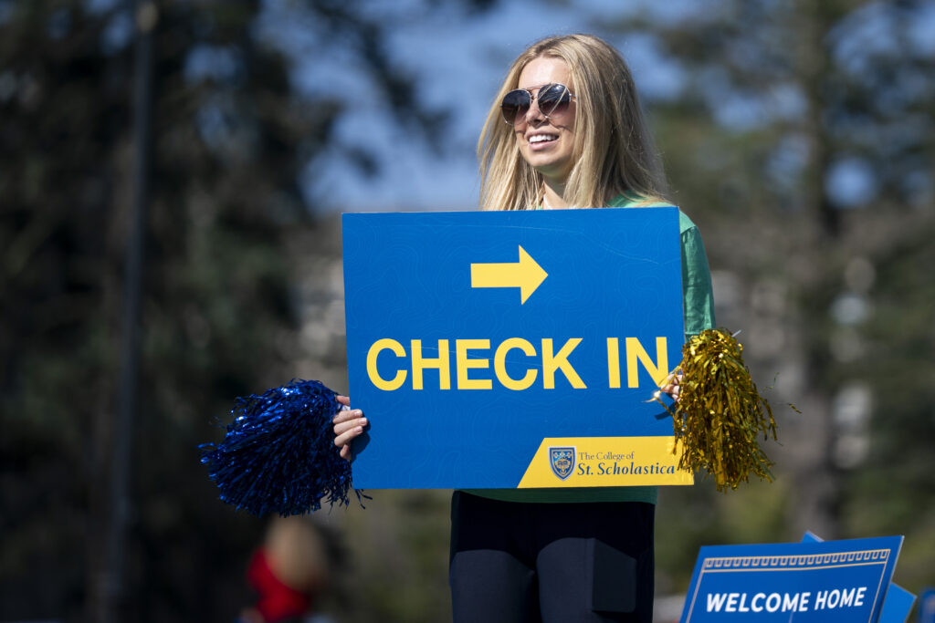 Delta Leader holds a check-in sign.