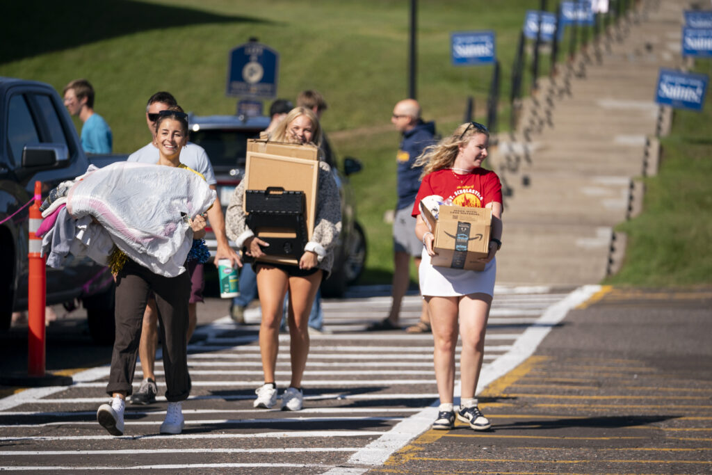 Families moving items into Somers Hall.