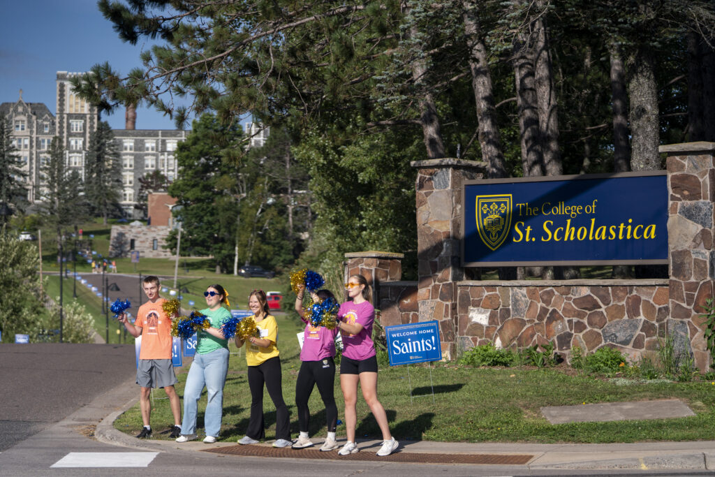 Delta Leaders near the entrance of St. Scholastica.