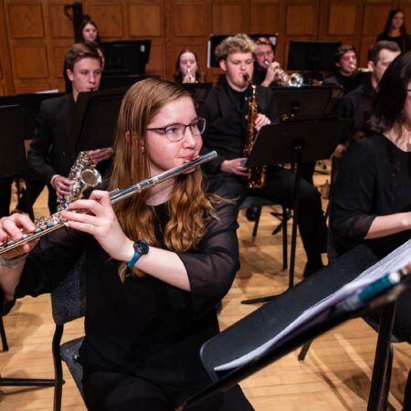 Group of St. Scholastica musicians playing in a performance.