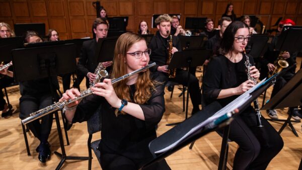 Group of St. Scholastica musicians playing in a performance.