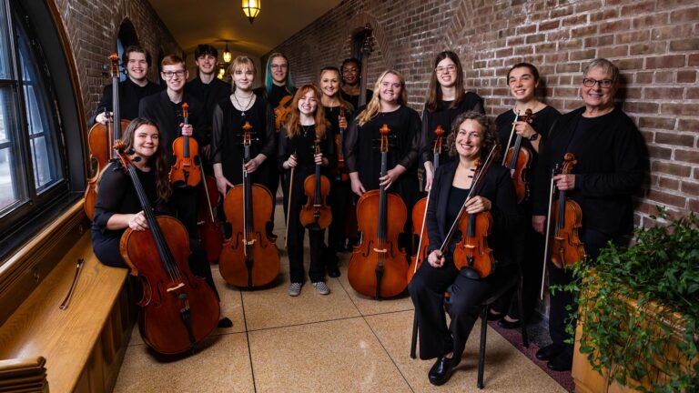 Group of musicians playing in the St. Scholastica Orchestra.