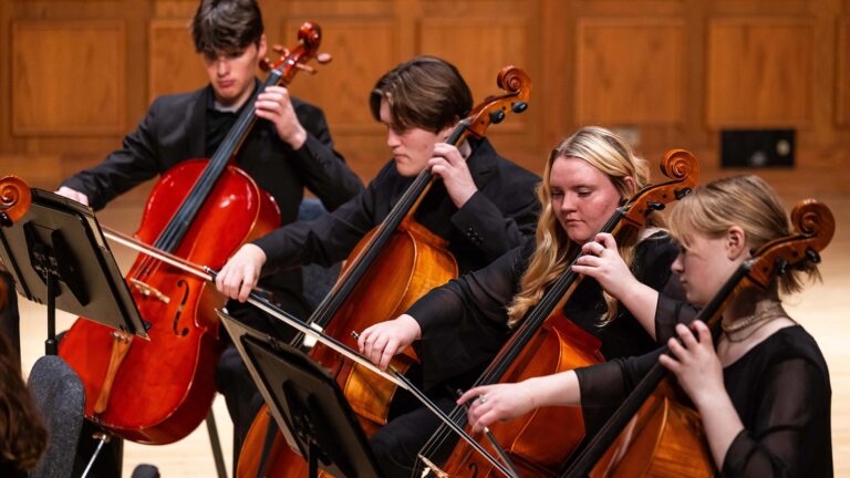 St. Scholastica students playing in the String Orchestra in the Mitchell Auditorium.