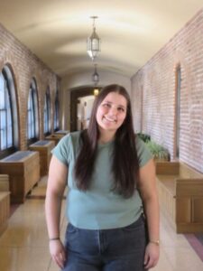NaImah Shouman standing in the cloister walk of St. Scholastica.
