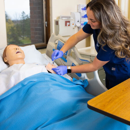 St. Scholastica student practicing giving a shot in a Simulation Lab.