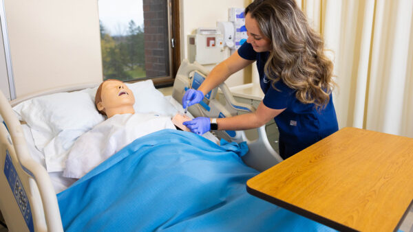 St. Scholastica student practicing giving a shot in a Simulation Lab.