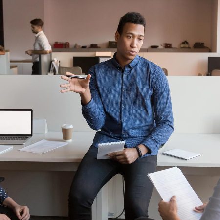 Three professionals in an office setting.