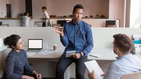 Three professionals in an office setting.