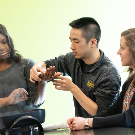 Students practicing splinting in the Assistive Technology Lab at St. Scholastica.