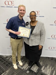 Owen Erickson receives certificate for COE Summit.