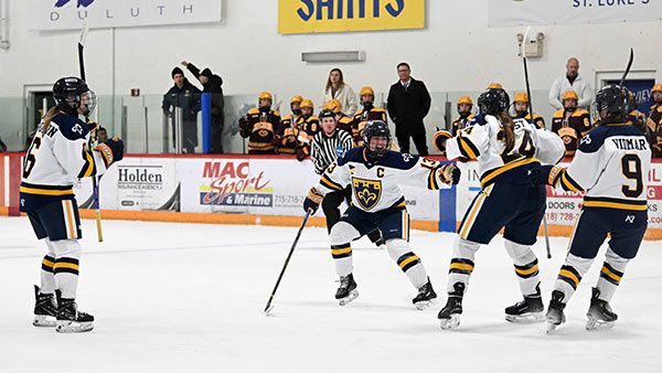 Photo of the St. Scholastica women's hockey team, featuring captain Paige Blattner