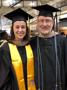 Pedersen and Professor Bob Hartl during Commencement in 2019.