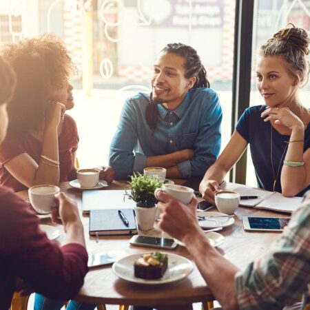 A group of students sitting around a table having a philosophical discussion.