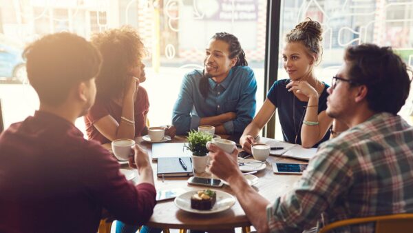 A group of students sitting around a table having a philosophical discussion.