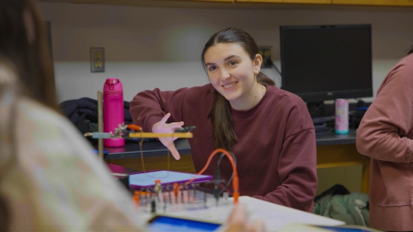 Student engaging in a physics lab.