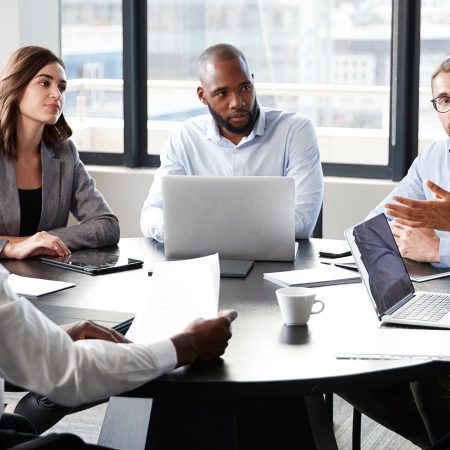 Professionals meeting around a conference table.