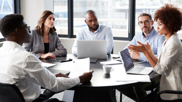 Professionals meeting around a conference table.