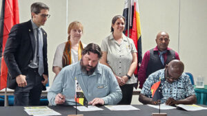 The signing of a partneship between Poplar, Wisconsin and Papua, New Guinea.