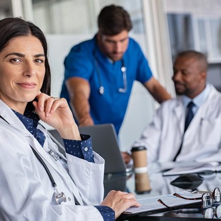 Healthcare workers sitting around a conference table.