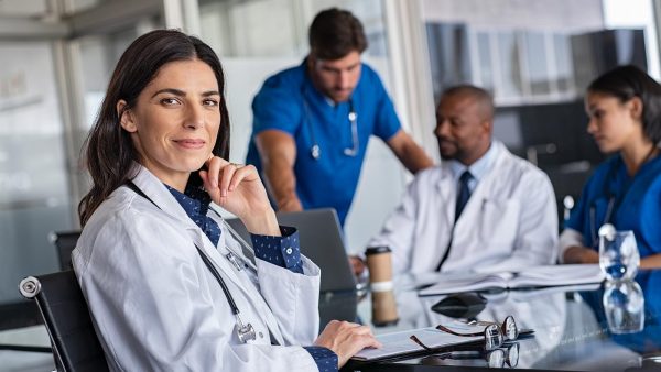 Healthcare workers sitting around a conference table.
