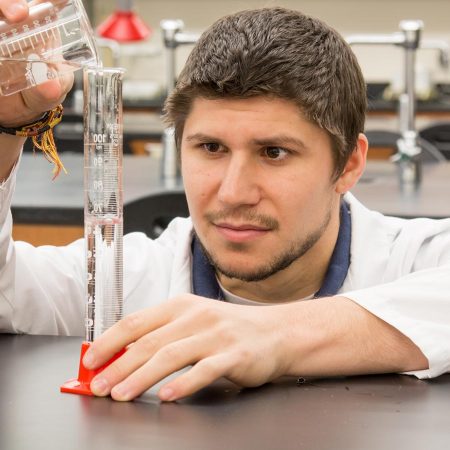 Student working in a science lab at St. Scholastica