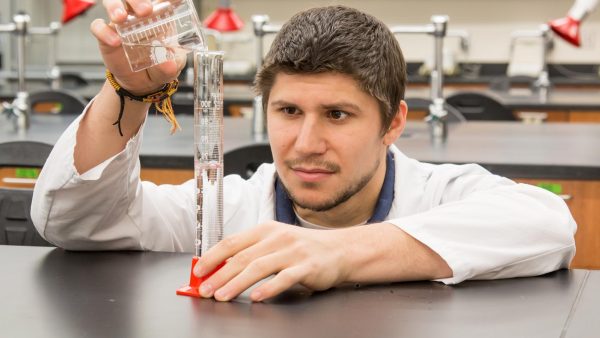Student working in a science lab at St. Scholastica