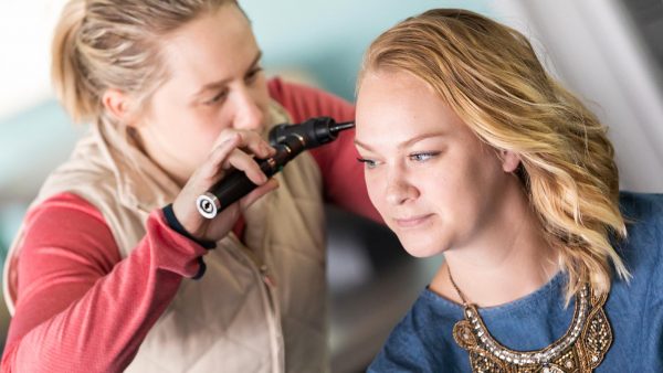 Two Physician Assistant students learning a procedure in a lab.