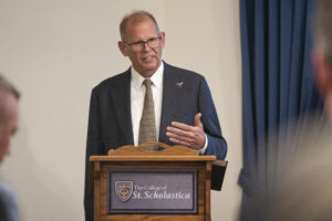 President Edward Inch speaks at podium.
