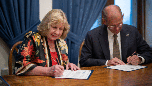 The presidents at St. Scholastica and Minnesota State Mankato sign the engineering agreement.