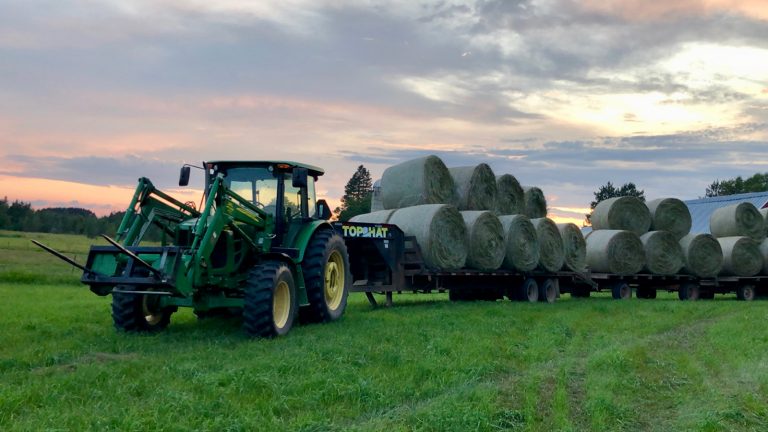 tractor hauling load of hay