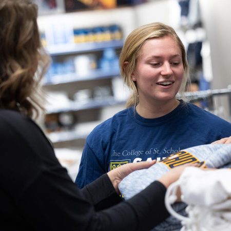 Two students shopping in the Saints Shop