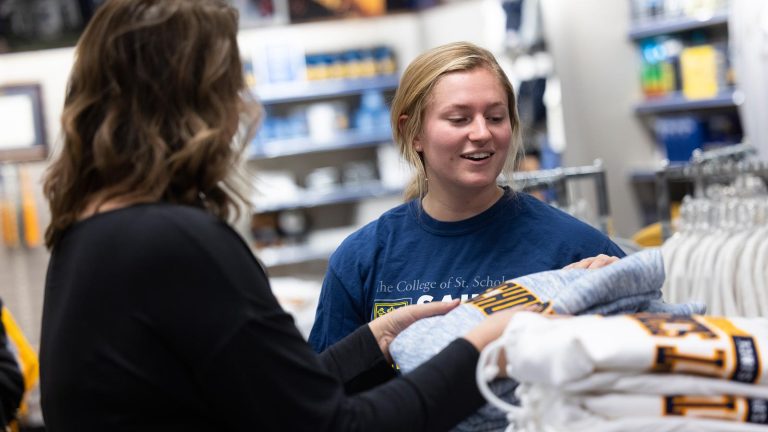 Two students shopping in the Saints Shop