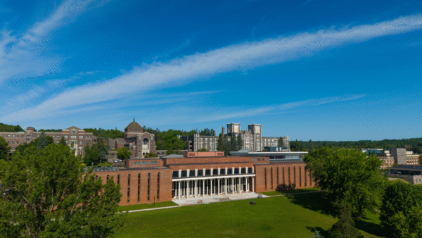 Science Center with Tower Hall in the background. The sky is bright blue and sunny.