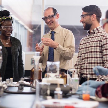 Professor teaching students in a science lab at St. Scholastica.