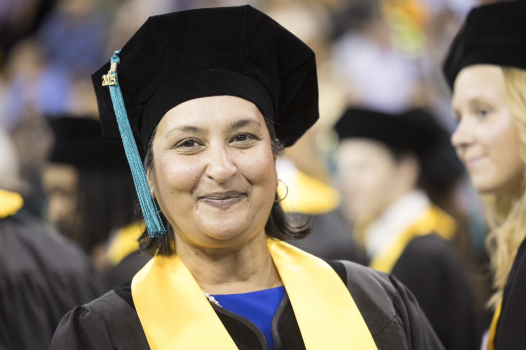 Student smiles at graduation.