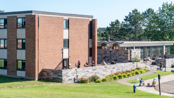 Students move items into Somers Hall.
