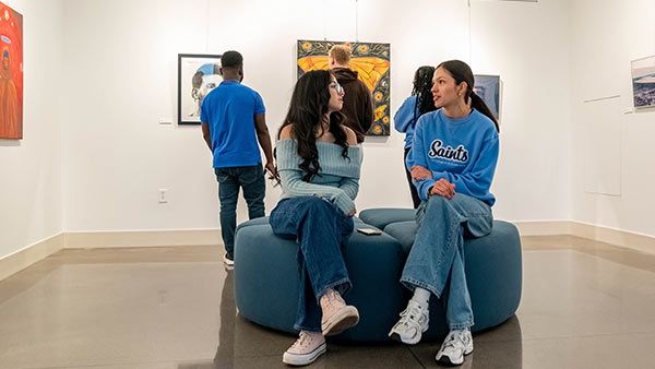 St. Scholastica students at an art exhibit in the Student Center.