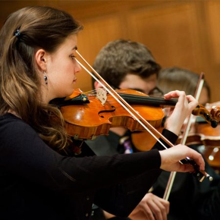 St. Scholastica students performing in a concert in the Mitchell Auditorium.