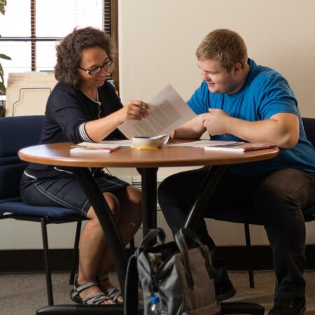 Student working with a staff member to obtain academic support.