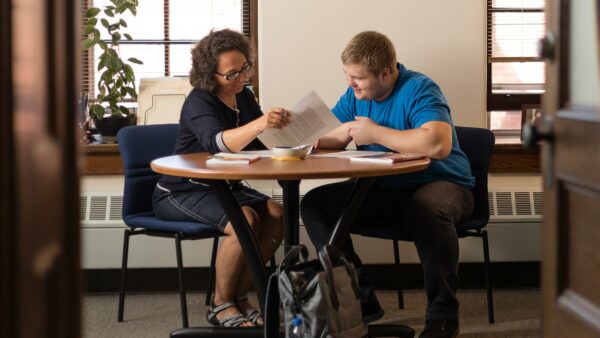 Student working with a staff member to obtain academic support.